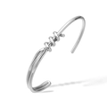 Detail of silver twisted knot cuff bracelet featuring a minimalist open-ended wrap design - Silver