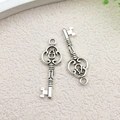 Pair of antique silver hollow key charms for DIY jewelry making and craft projects - Hollow Pattern Key