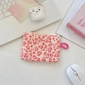 Flat lay of pink heart leopard print coin purse with wrist strap and laptop background - Corduroy Leopard Heart Pink