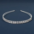 Detailed close-up of a silver tiara headband with sparkling rhinestones on blue background - Simple Transparent Crystal Style (DFK1015)