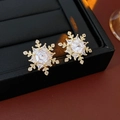 Macro shot of gold-plated snowflake stud earrings featuring clear zircon and fine craftsmanship - Gold Plated Zircon Snowflake Earrings