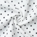 Detail view of lightweight white fabric with classic black polka dots and soft texture - S / Black