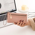 Detail of pink pebbled leather wallet with golden leaf zipper and detachable wrist strap - Pink