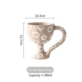Artisanal light beige ceramic goblet with hand-painted white circles and waist handle - Polka Dot Goblet Mug