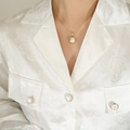 Elegant gold snake chain necklace with a white pearl pendant shown on a model neck - Gold White Faux Pearl Necklace
