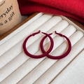 Detail view of red velvet hoop earrings on jewelry tray with elegant autumn atmosphere - Red (Silver Earring Post)