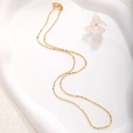 Close-up of gold plated thin ball chain necklace with a lobster clasp on white tray - A0149 Interspersed Bead Chain