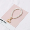 White glass pearl phone chain with golden heart charm and clasp on pink card - KC Gold Heart Style