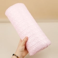 Detail of light pink hand rest with quilted heart pattern and glossy PU leather texture - Semicircle Heart Nail Pillow Pink