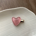 Close-up of pink heart-shaped resin hair clip with golden metal base on ceramic plate - Jelly Heart Hair Clip-Pink