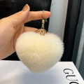 White heart-shaped rex rabbit fur keychain with gold metal clasp on a soft plush ball - Milky White
