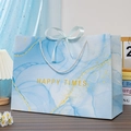 Light blue marble gift bag with HAPPY TIMES gold lettering and silk bow accent - Blue Flowing Gold