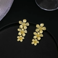 Elegant gold flower drop earrings with three-layer metal floral petals on black stand - Gold Triple Flower Eardrops (S3102-1)