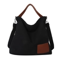 Minimalist black canvas tote bag with brown leather handles and adjustable shoulder strap - Black