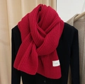 Cozy red knitted scarf for winter with woven label on soft black sweater - Red