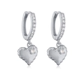 Detailed macro view of silver heart earrings with quilted texture and sparkling zircon pavé - Silver Padded Heart Earrings With White Zircon