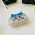 Detail of cream white acetate hair claw clip featuring cute blue-eared cartoon animal design - Blue Hair Red Cheeks Round Cat