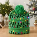 Detail of green knit Christmas hat with colorful glowing LED lights on wooden surface - Green Lantern Pattern