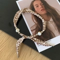 Leopard print fabric necklace with white beads and silver accents on wooden board - Necklace-Coffee