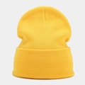 Detail of bright yellow knit beanie showing fine texture and wide fold-over cuff design - Yellow