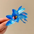 Elegant royal blue fabric flower hair clip with satin texture and yellow stamen detail - Blue Cymbidium