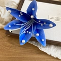 Close-up of a blue fabric lily hair clip decorated with elegant white pearls. - Lily Duckbill Clip / Blue-Single