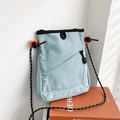 Detail of light blue nylon messenger bag with orange clip and black braided shoulder strap - Blue