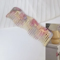 Macro shot of wavy acetate hair comb featuring pastel marble texture and wide teeth - 2# Fantasy Yellow