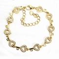 Macro detail of gold-plated heart and key link bracelet with micro-pave cubic zirconia - Heart & Key / Gold
