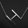 Minimalist silver-tone stainless steel necklace featuring a bold uppercase letter H pendant - White Letter H