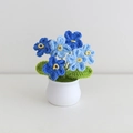 Handmade crochet forget-me-not potted plant in blue with a white ceramic pot - Forget-Me-Not Gradient Blue