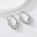 Close-up of minimalist irregular teardrop silver earrings on white stones - 1186 Steel Color Teardrop