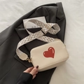 Creamy white crossbody bag with red heart graphic and vintage geometric woven strap - Off White