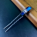Macro shot of iridescent crystal U-shaped hairpin with silver wire wrapping detail - Dark Blue