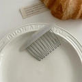 Detail of marble pattern acetate hair comb on ceramic plate with aesthetic ins style - Marble White