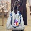 Detail of off-white nylon tote bag featuring blue webbing and artistic illustration - Blue-gray Embrace Yourself (Without Shoulder Strap)