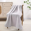 Light gray coral fleece towel with vertical striped texture hanging on a wooden chair - Bath Towel (70x140cm) / Light Gray