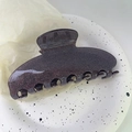 Y2K starry sky hair claw clip with dark glitter finish on decorative ceramic plate - Black