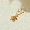Collana con pendente a stella con pietre di zircone arancione su catena dorata fine - Zirconia Arancione