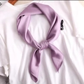 Solid purple silk square scarf knotted on white t-shirt for professional neck styling - Purple