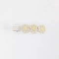 Close-up of three cream embroidered knit flowers on a fabric-covered hair clip - Cream Beige
