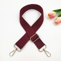Close-up of burgundy canvas strap with golden metal swivel hooks and adjustable buckle - Dark Wine Red