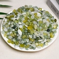 Polished green and yellow quartz stone chips displayed on a white decorative plate - Xiuyan Jade (7-9mm) 100g