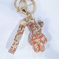 Sparkling crystal bear keychain with orange and iridescent rhinestones on a gold lobster clasp - Mixed Orange