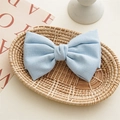 Detail of light blue fabric knotted bow hair clip made of breathable linen cotton texture - Light Blue
