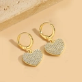 Close-up of gold heart earrings with pavé crystals on a textured stone display - White Heart Style (ES2618-1)