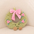 Detail of Christmas plush wreath with a pink bow, cute embroidered face and brown feet - Sweet Wreath with Legs
