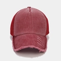 Macro shot of red distressed mesh trucker hat showing vintage wash and torn details - Adjustable / Burgundy