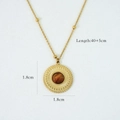 Detail of 14k gold plated necklace with round tiger eye stone pendant and sunburst texture - Embossed
