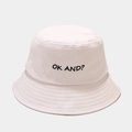 Detailed view of black OK AND embroidery on a high-quality white cotton bucket hat - M (56-58cm) / Beige